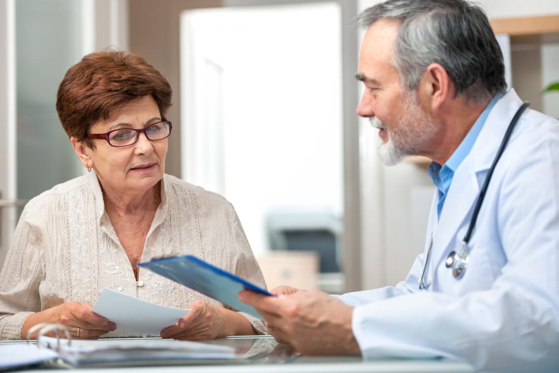 doctor explaining something to older lady