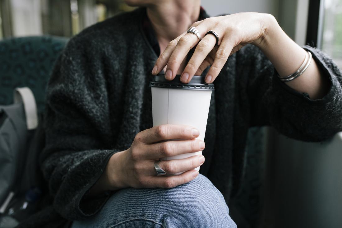 https://cdn-prod.medicalnewstoday.com/content/images/articles/324/324768/woman-experiencing-caffeine-withdrawal-holding-takeaway-cup-of-coffee-on-public-transport.jpg
