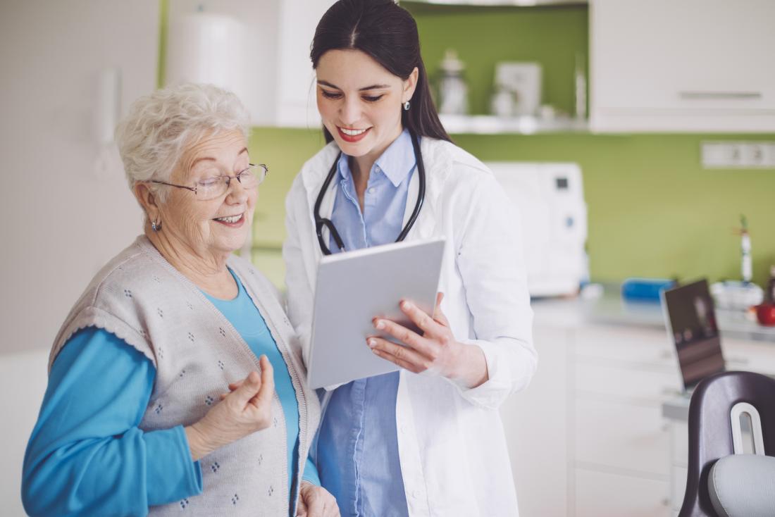 older lady looking at blood pressure results with doctor