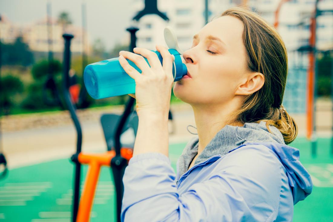 Woman drinking water with electrolytes