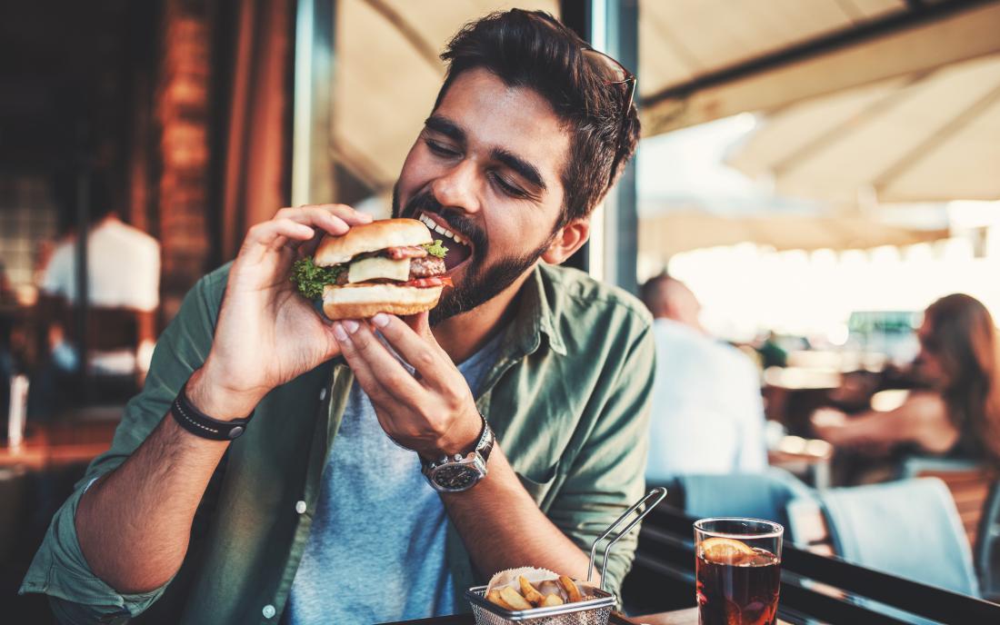man eating a burger