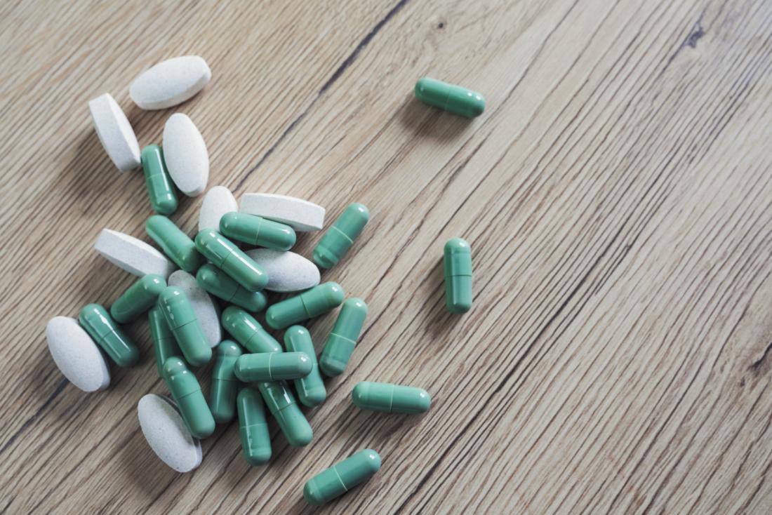 probiotic supplements on a wooden background