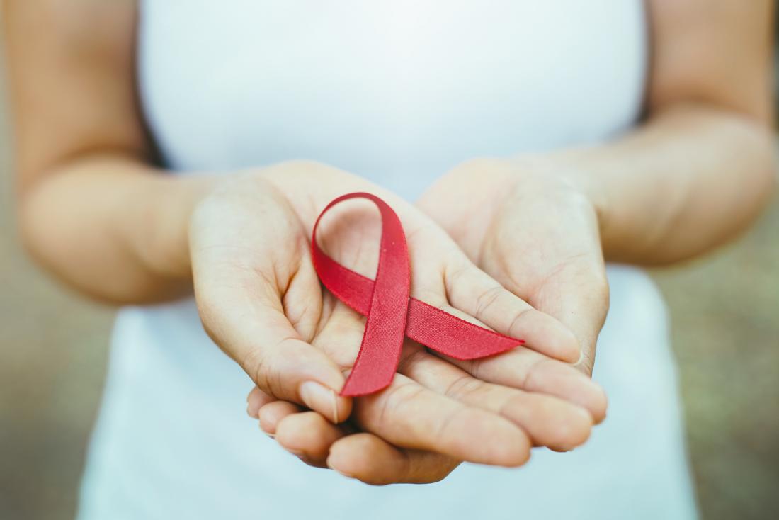 woman holding aids ribbon