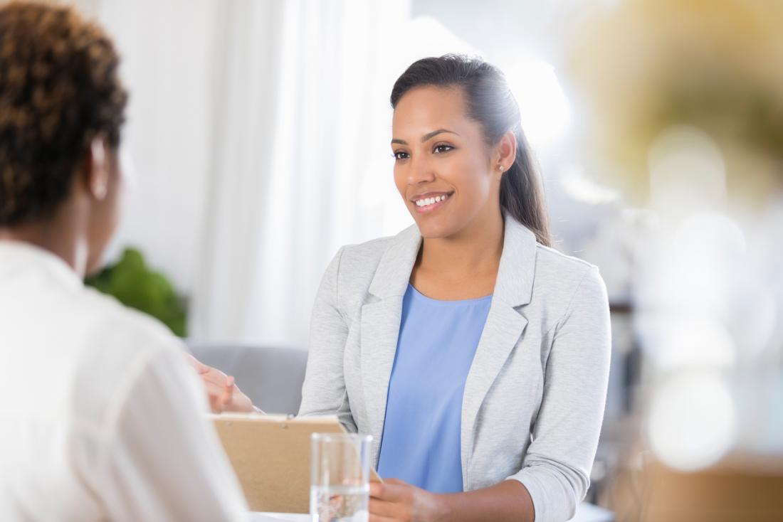 doctor speaking to a patient in light filled space