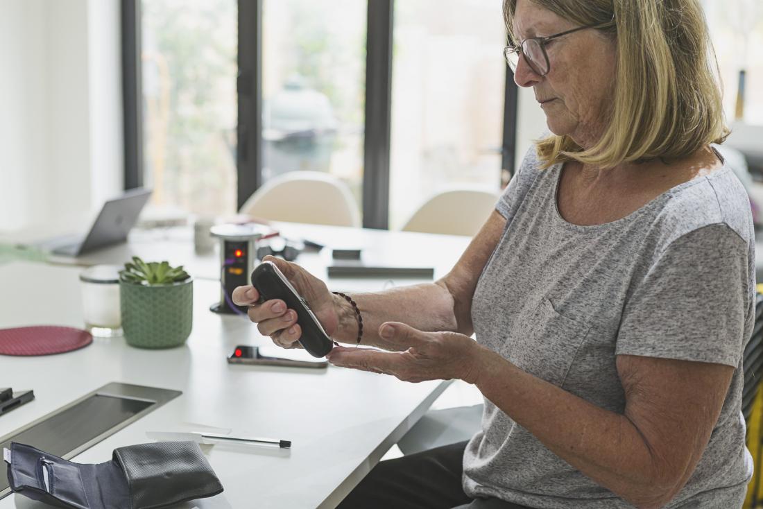 woman checking cholesterol measurements