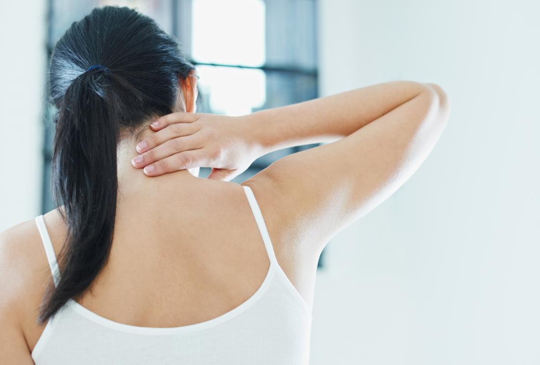 What Can Cause A Lump On The Back Of The Neck Hairline   Woman Holding Back Of Neck And Shoulder 