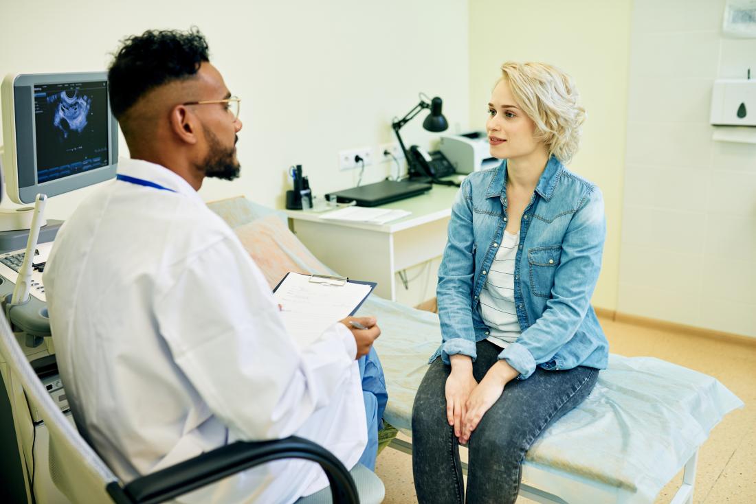 Woman in doctor or gynecologists office after ultrasound