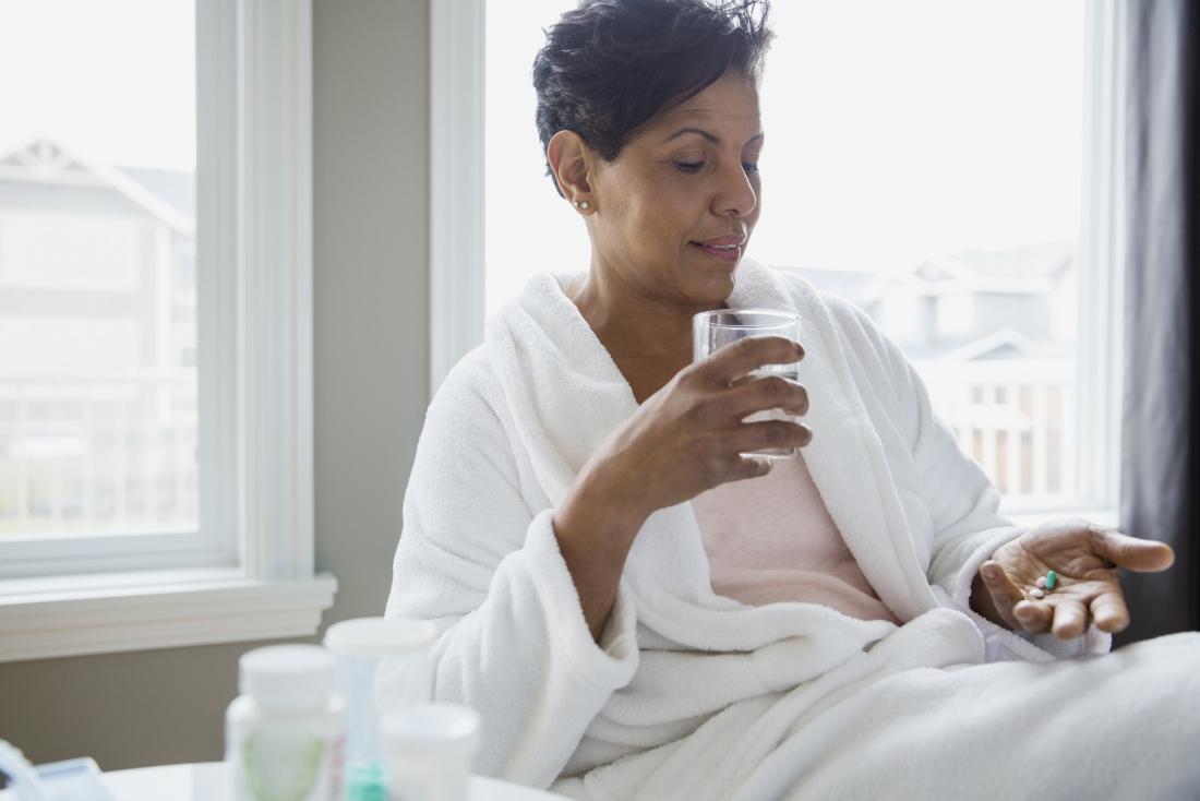 woman taking medicine