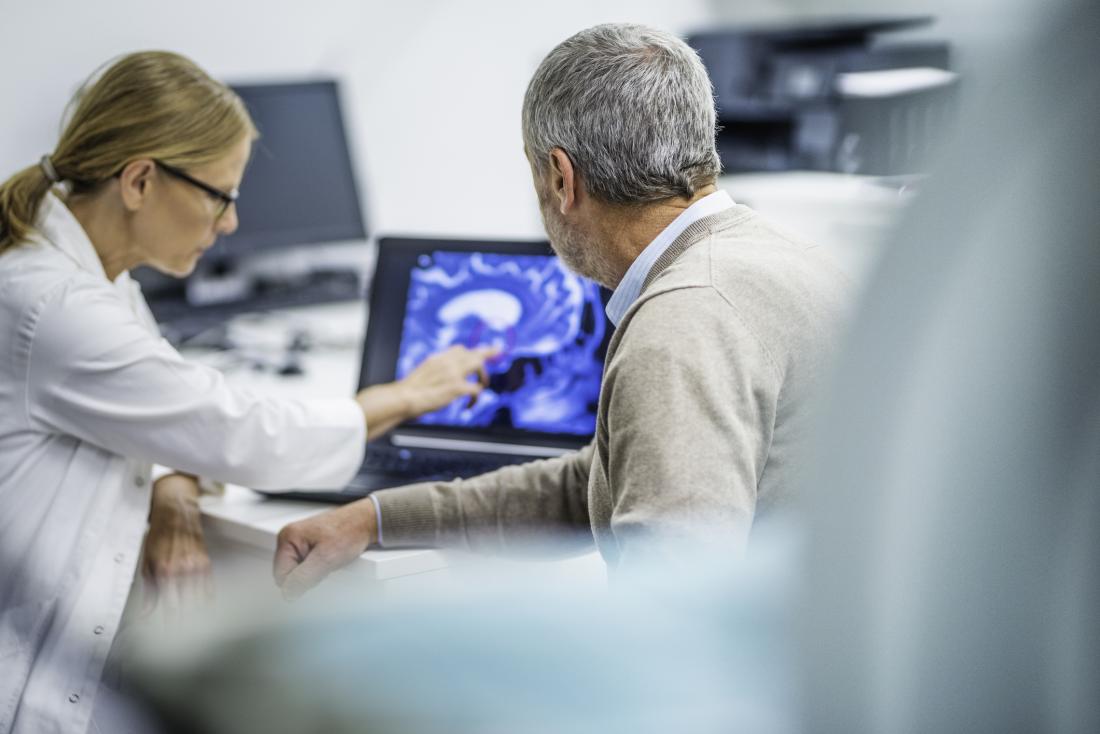 doctor showing patient their brain scan