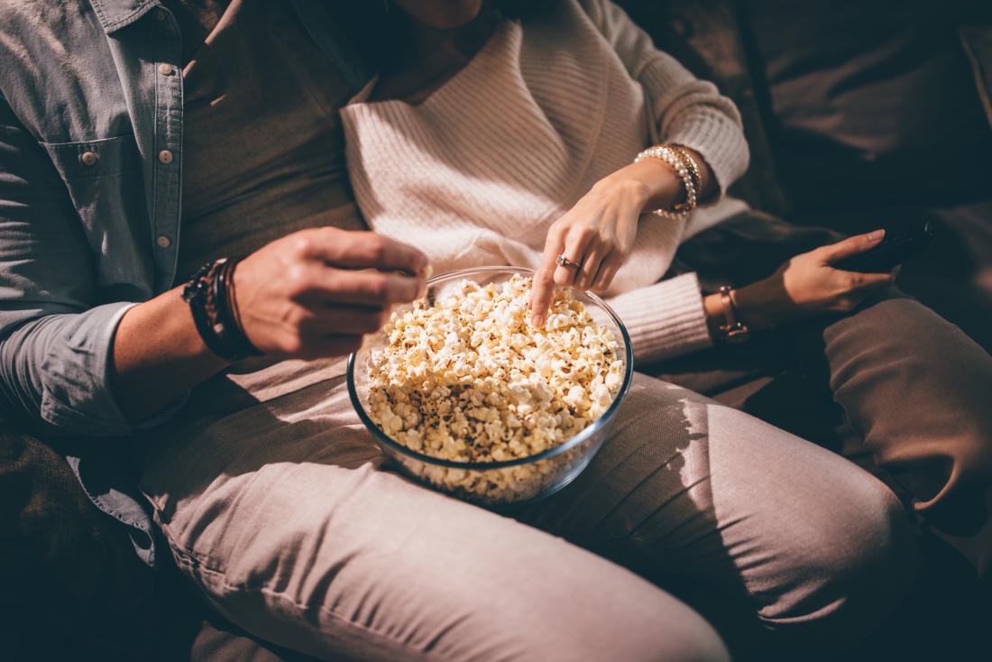 Couple snacking on popcorn