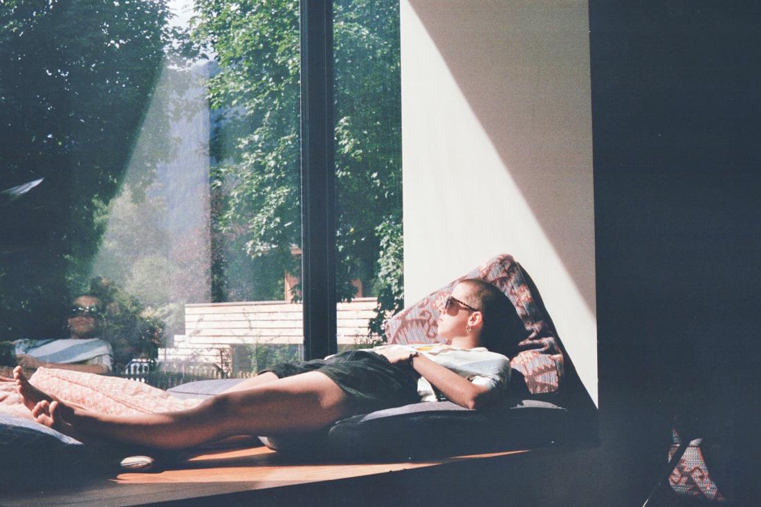 person relaxing by a window