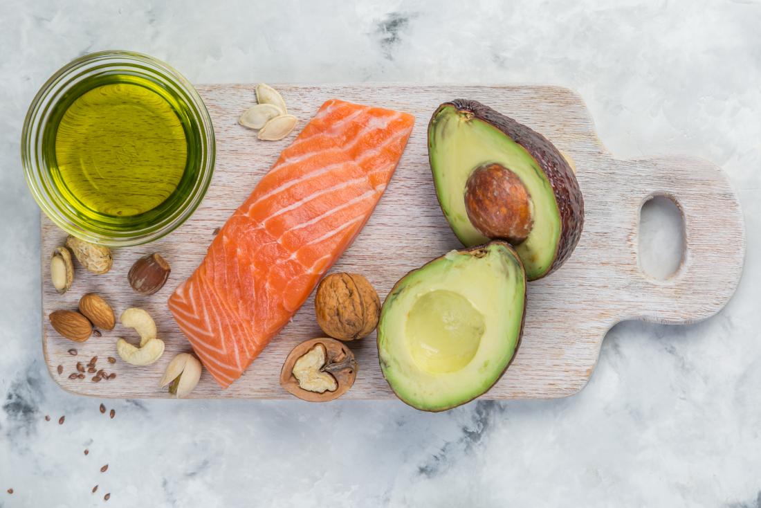 salmon, nuts and avocado on a board which are part of low carb diet for diabetics