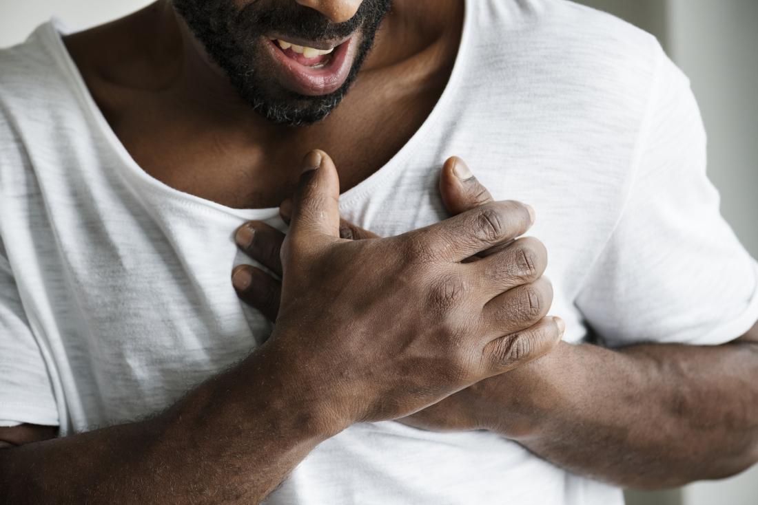 man holding chest in pain due to diaphragm spasm