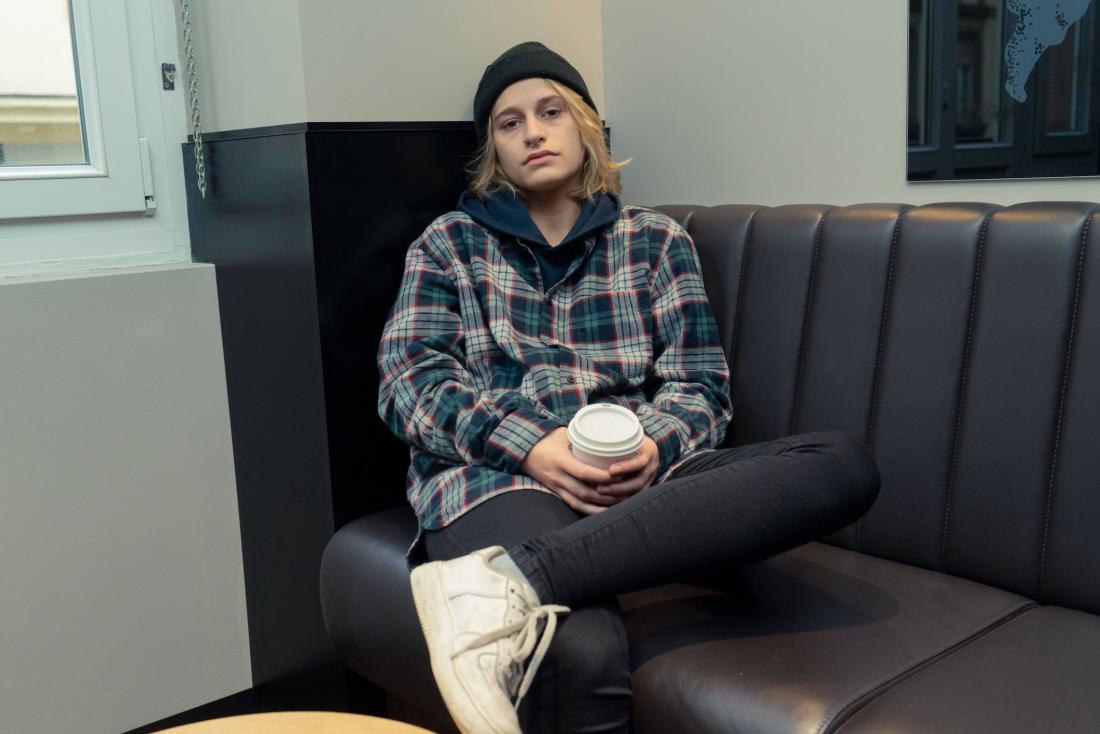 stressed person sitting on the sofa holding a drink