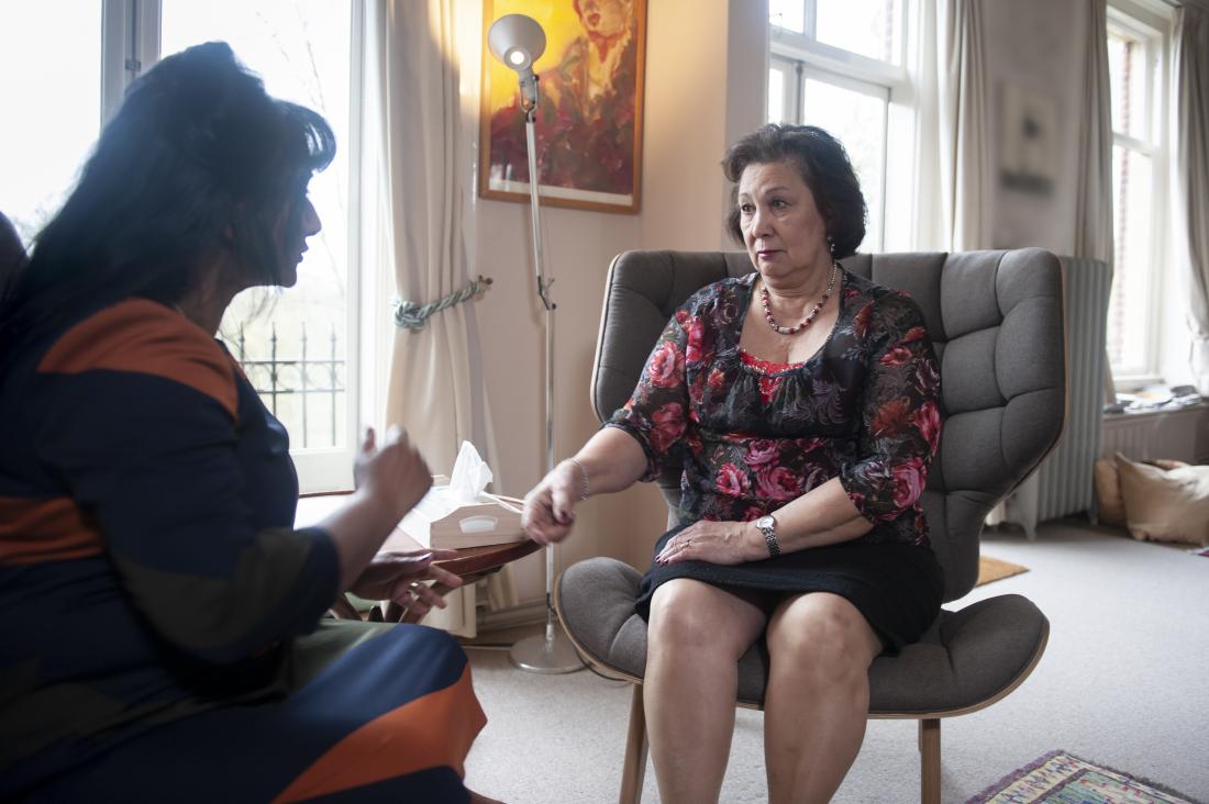 Mature senior woman having counseling or CBT therapy in psychotherapists office.