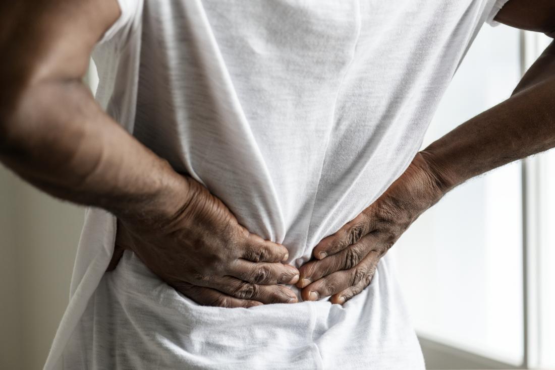 Lower Back Pain Causes Treatment And When To See A Doctor   Person Experiencing Lower Back Pain 