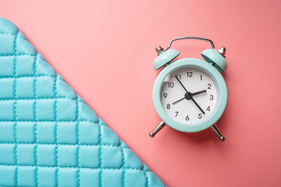 blue clock on a pink background