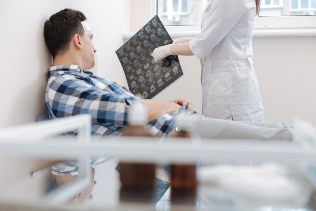 doctor showing man xrays of his brain