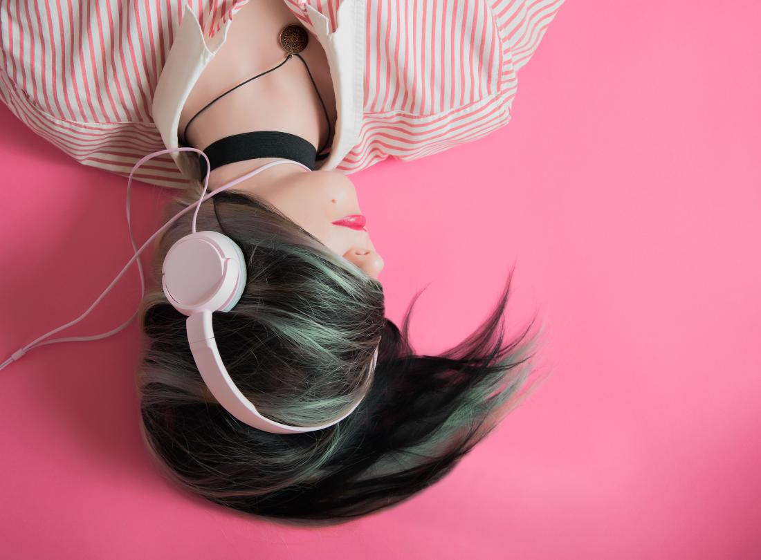 person listening to music through headphones