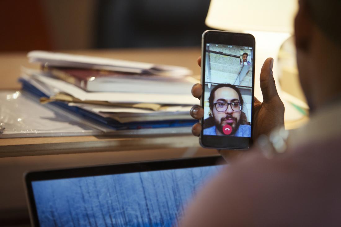 person videoconferencing with therapist