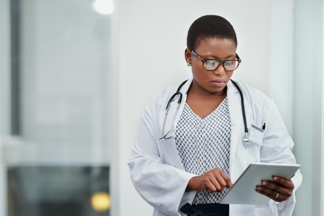 doctor checking medical record, looking concerned
