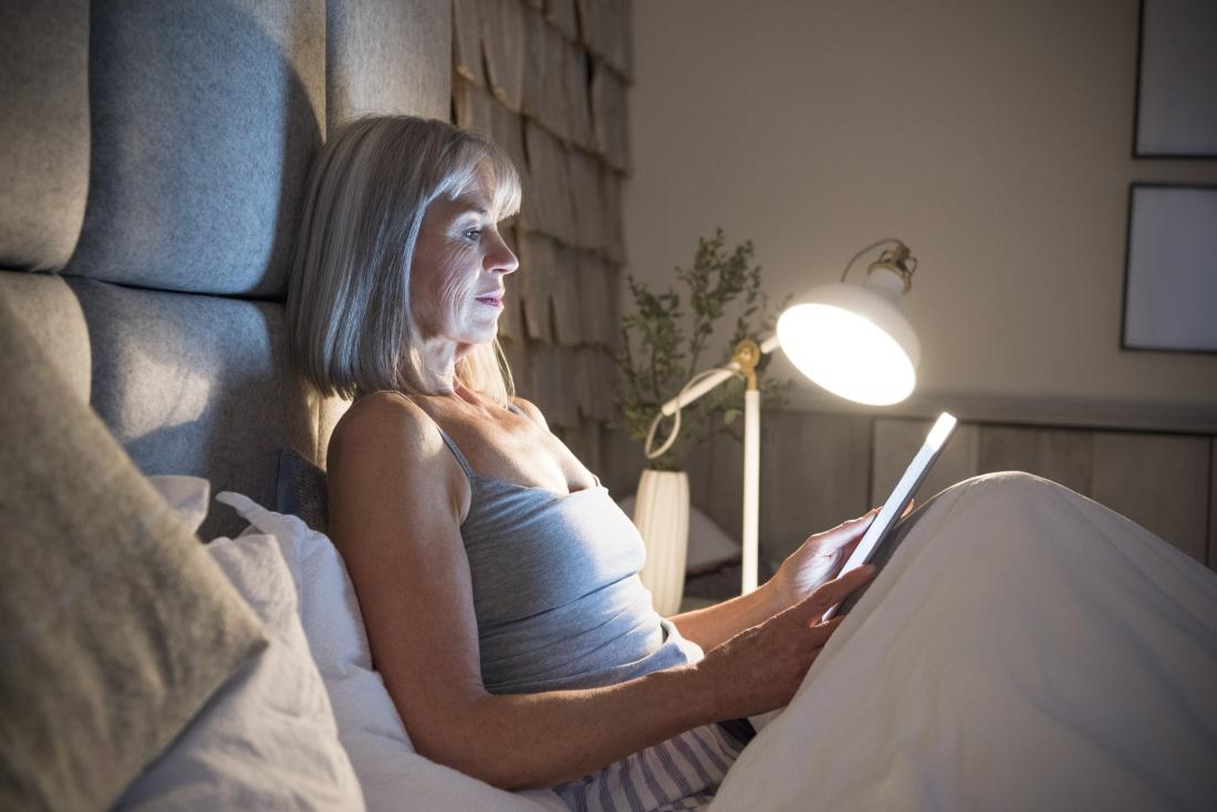 woman reading in bed at night