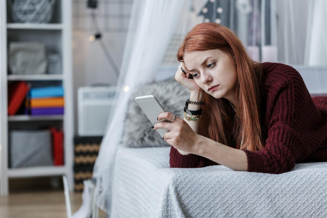 Teenager with aspergers and adhd looking at smartphone