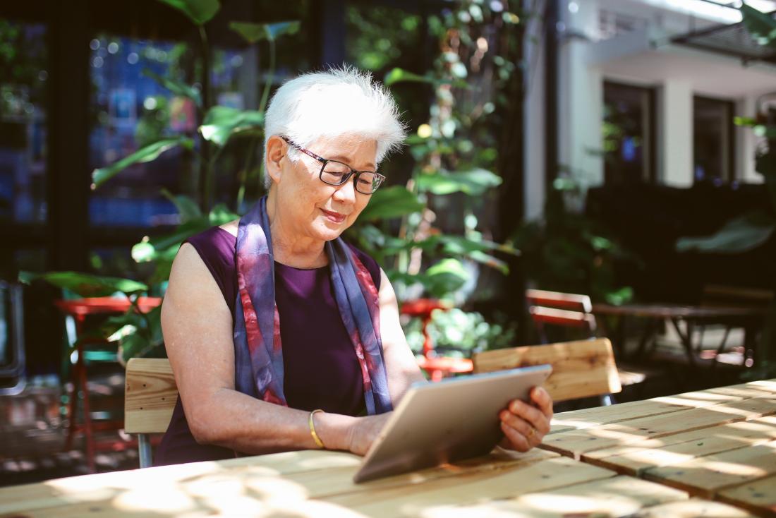 senior woman reading on a tablet