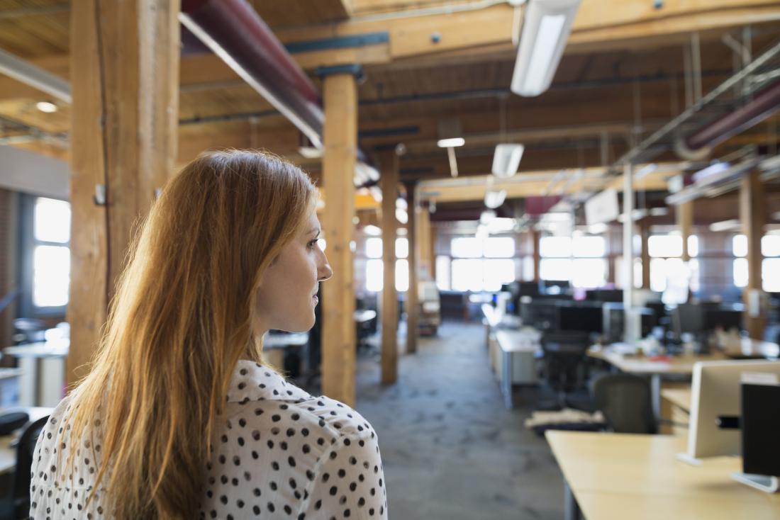 woman looking around in an office. 