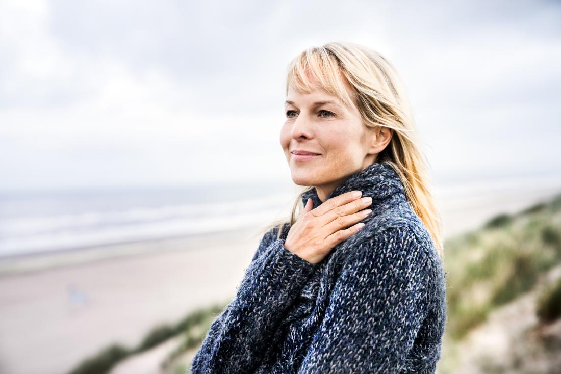 Woman looking out to sea. During the early stages of pregnancy, the cervix undergoes many changes.