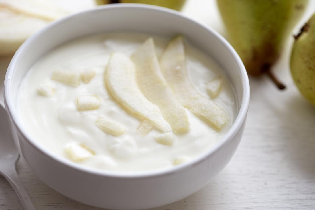 A bowl of yogurt and pear.