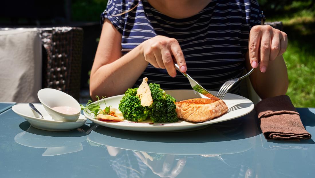 A woman eating fish