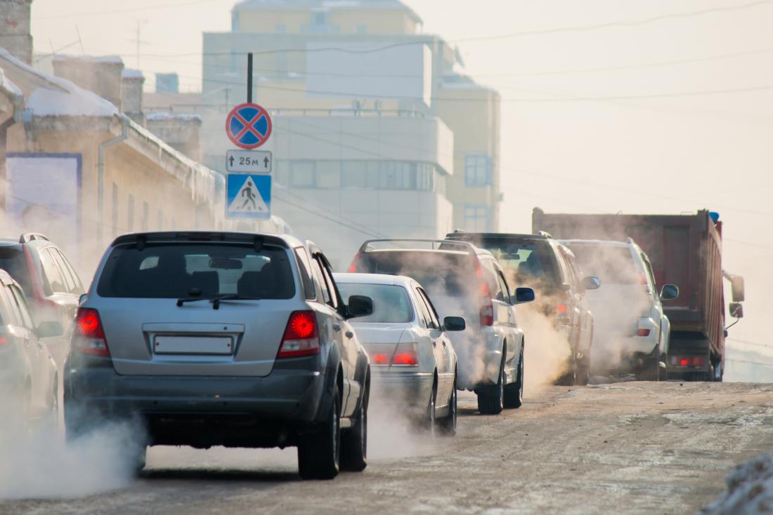 Cars causing pollution on a busy road.