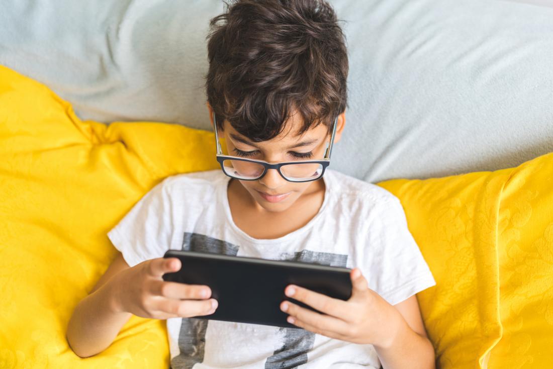 A child playing on a handheld game console.