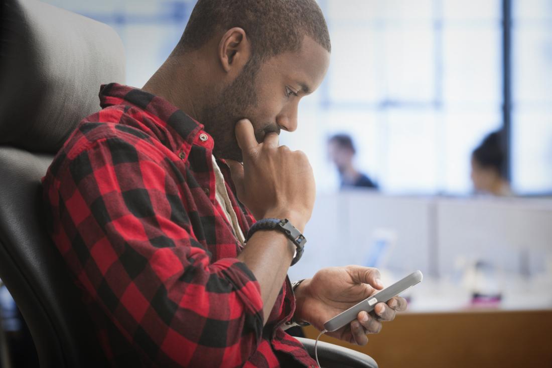 A man on his phone that may suffer from autism or adhd.