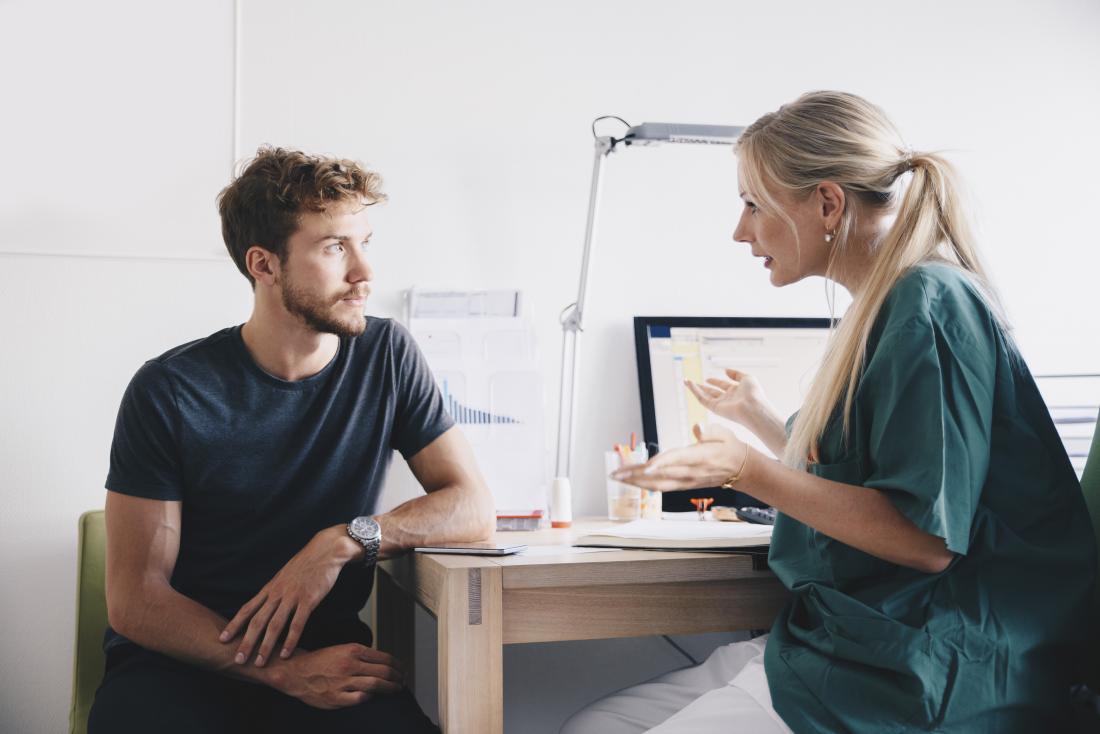 doctor talking to patient about chancroid in office