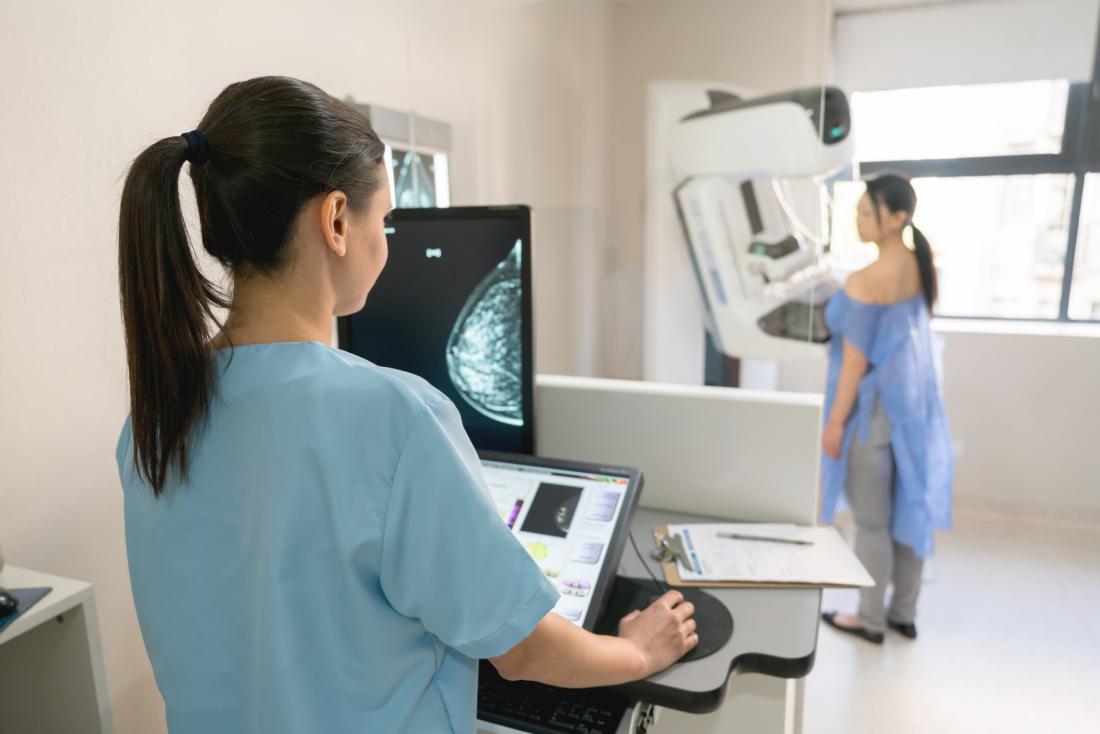 physician looking at patient s mammogram