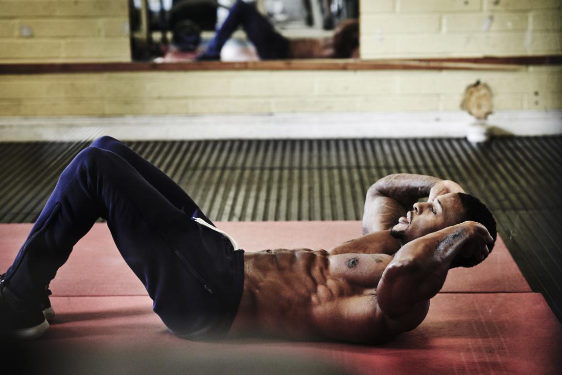 young man doing sit ups