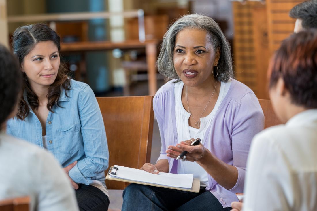 mental health professional facilitating group therapy