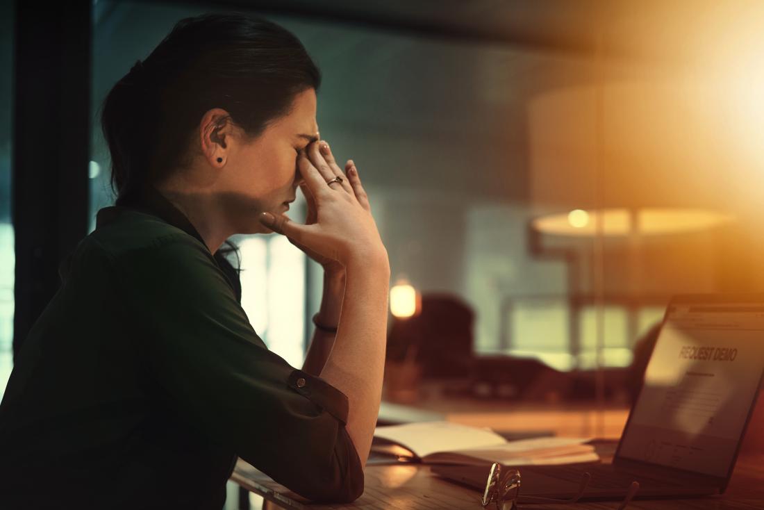 Woman holding her head due to migraine and kaleidoscope vision