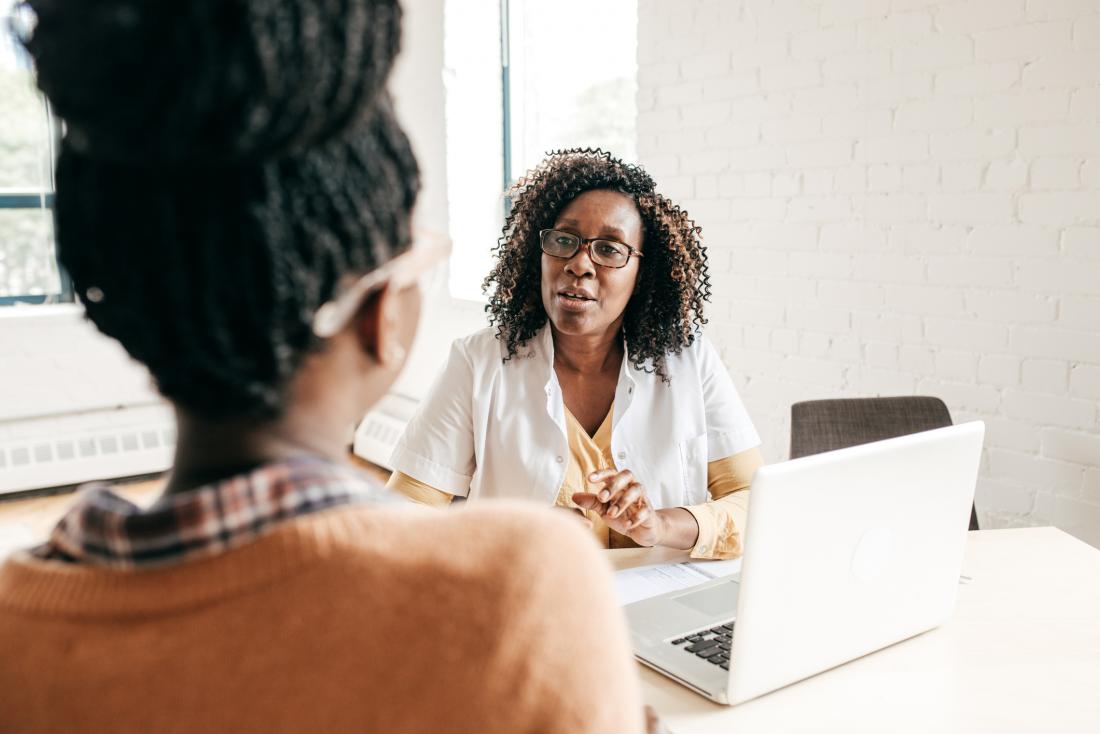 female doctor talking with female patient