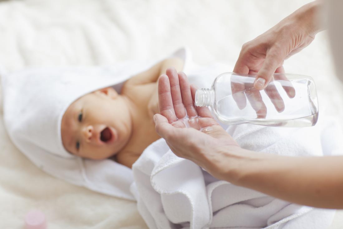 a baby about to get some baby oil applied for cradle cap. 