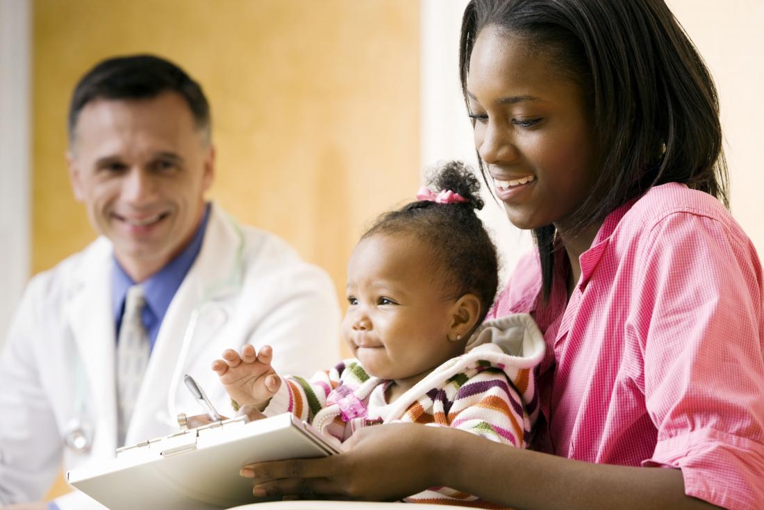 a baby and mother visiting a doctor. 