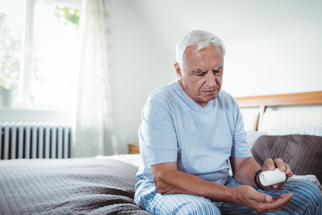 older man taking medication