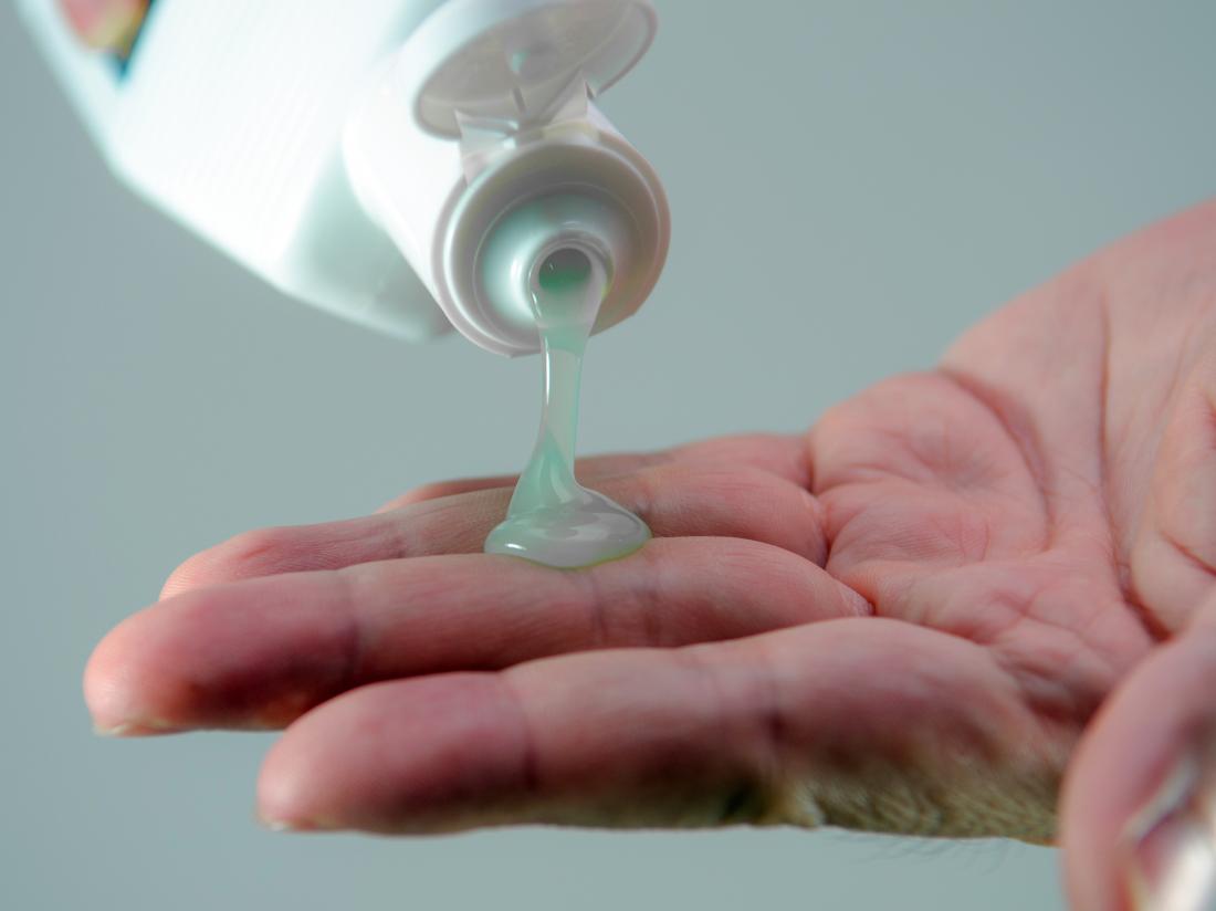 aloe vera gel getting poured onto a hand. 