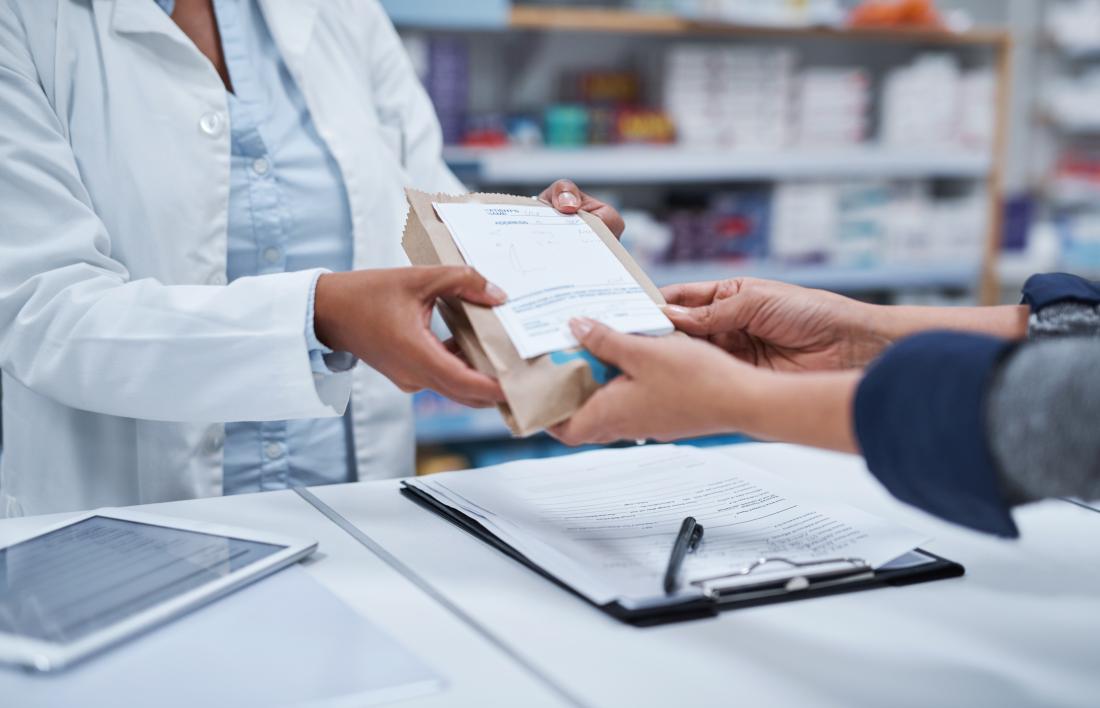 pharmacist handing over medicine