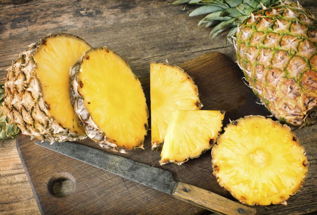 sliced pineapple on chopping board