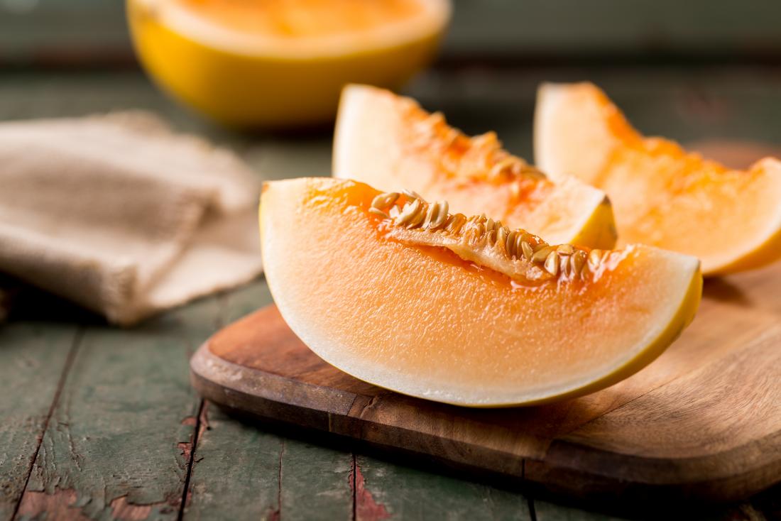 Sliced ripe Cantaloupe on a cutting board stock photo