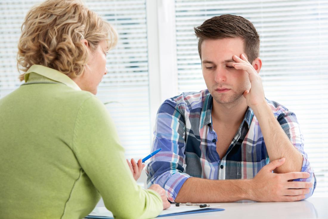 young man speaking to his doctor