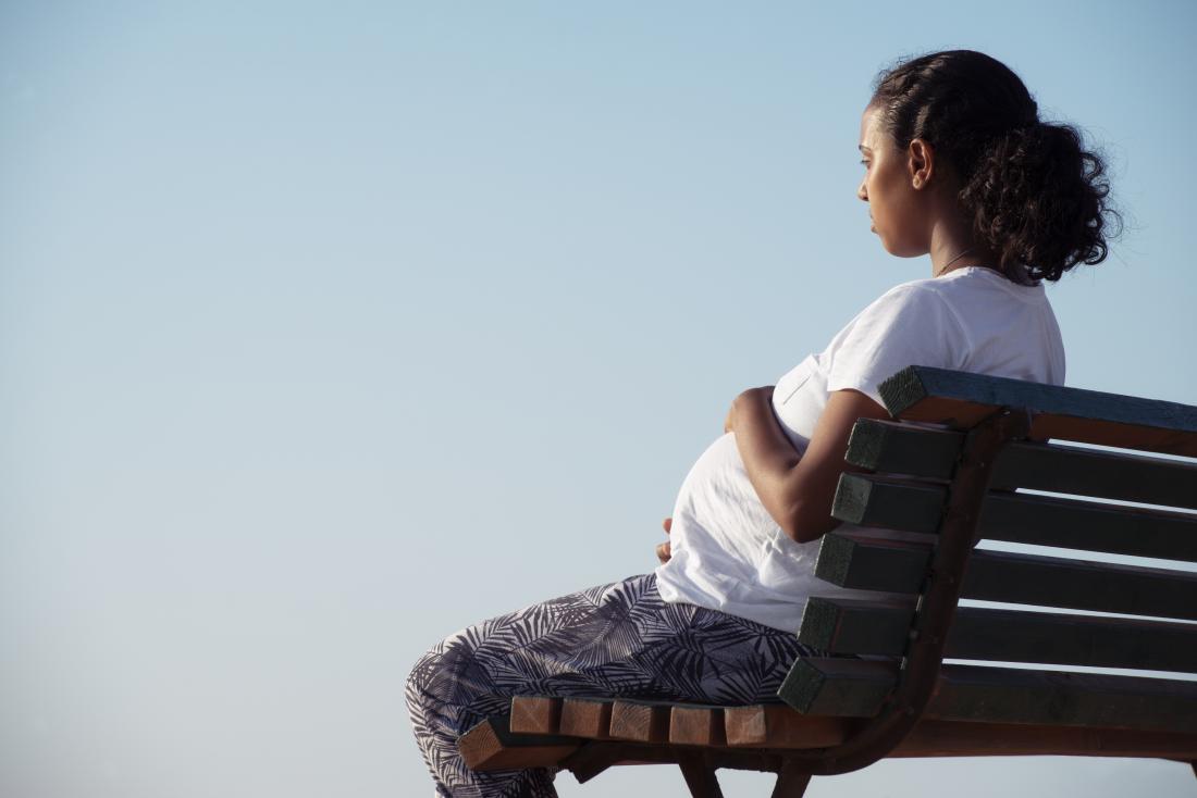 pregnant woman sitting on a bench